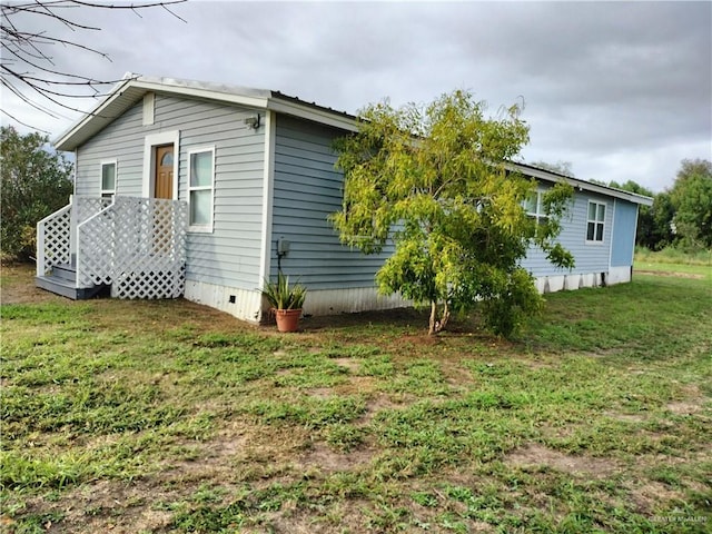 9458 Charles Green Rd, Edcouch, TX 78538 - view of side of property with a lawn