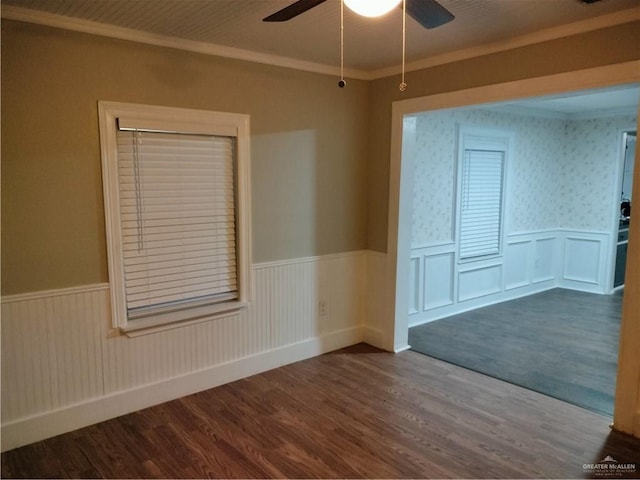 9458 Charles Green Rd, Edcouch, TX 78538 - empty room featuring a wainscoted wall, a ceiling fan, dark wood-style flooring, and crown molding