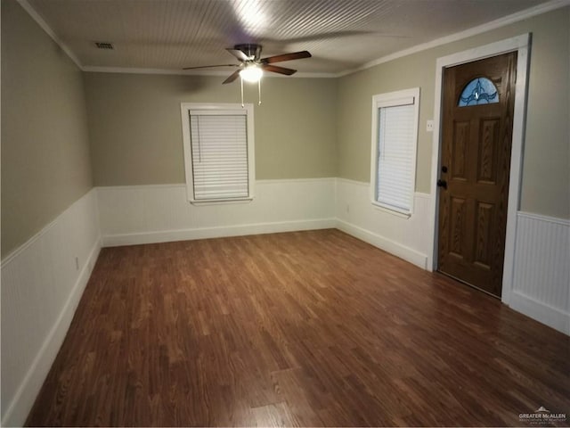 9458 Charles Green Rd, Edcouch, TX 78538 - foyer with ornamental molding, a wainscoted wall, a ceiling fan, and dark wood-type flooring
