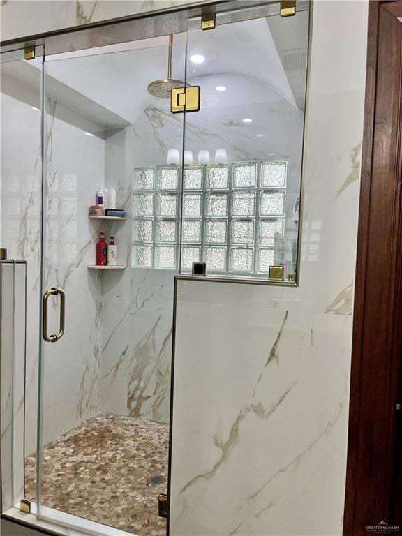 bathroom with a shower with shower door