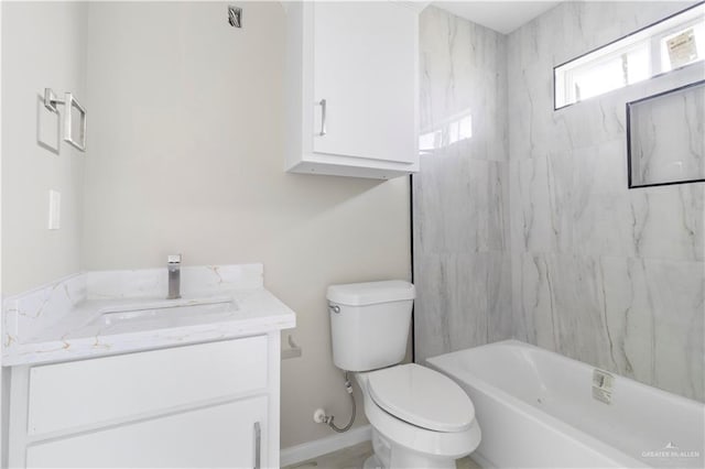 full bathroom with tiled shower / bath combo, vanity, and toilet