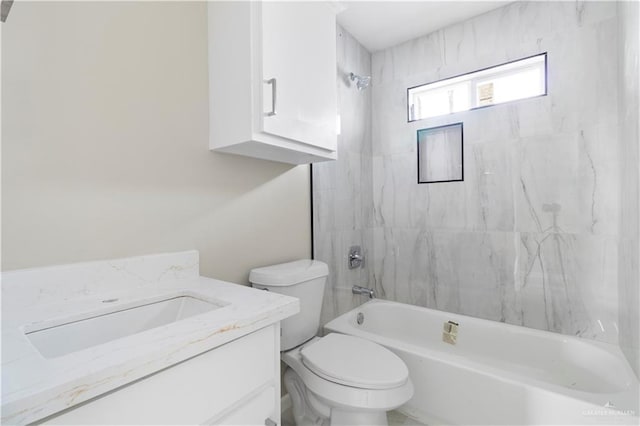 full bathroom featuring vanity, tiled shower / bath combo, and toilet