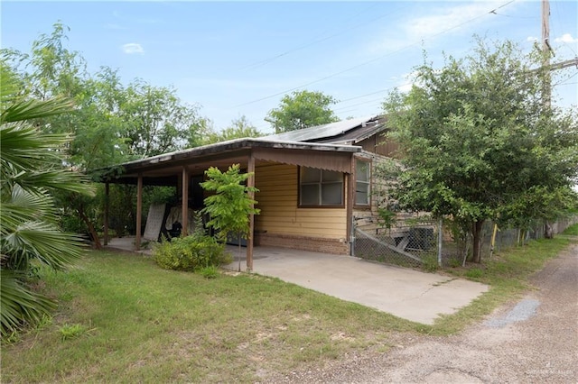 view of property exterior with a lawn and a carport