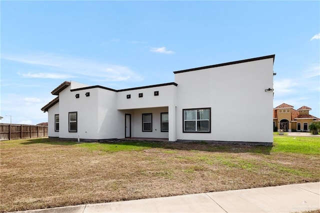 rear view of house featuring a yard