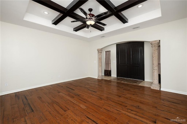 unfurnished room featuring coffered ceiling, beam ceiling, dark hardwood / wood-style flooring, and decorative columns