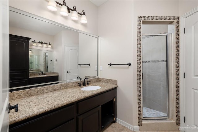 bathroom with tile patterned flooring, vanity, and a shower with shower door