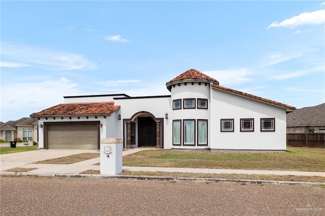 mediterranean / spanish house with a front lawn and a garage