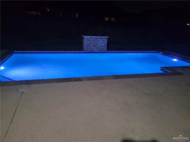 view of pool at night