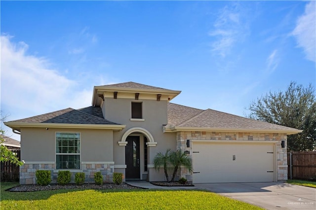 view of front facade featuring a front yard and a garage