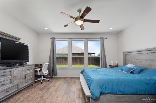 bedroom with ceiling fan and light hardwood / wood-style flooring