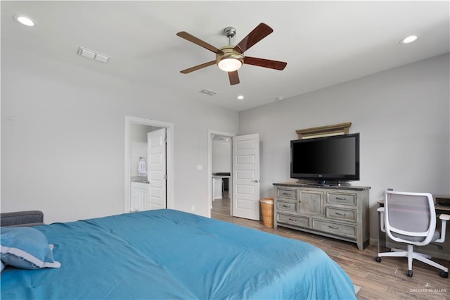 bedroom with hardwood / wood-style flooring, ceiling fan, and ensuite bathroom