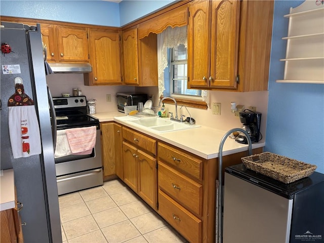 kitchen with light tile patterned flooring, appliances with stainless steel finishes, and sink