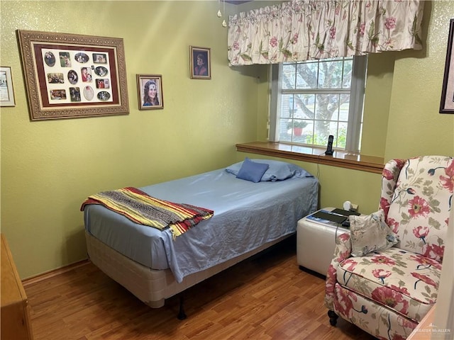 bedroom with wood-type flooring