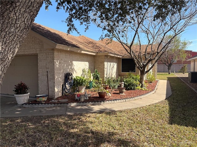 view of side of property featuring a yard and a garage