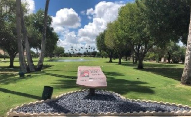 view of property's community featuring a yard and a water view