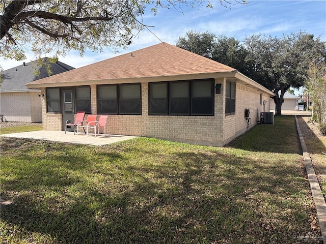 back of property with a patio area and a yard