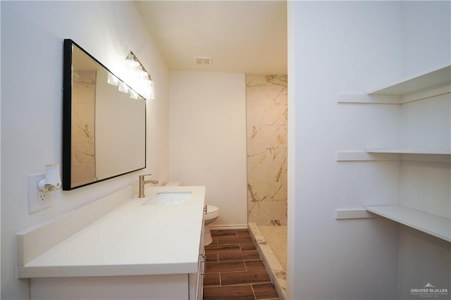 bathroom with vanity, toilet, and walk in shower