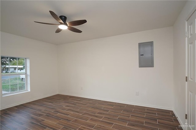 unfurnished room featuring electric panel, ceiling fan, and dark wood-type flooring