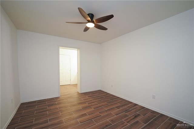 empty room with dark hardwood / wood-style flooring and ceiling fan