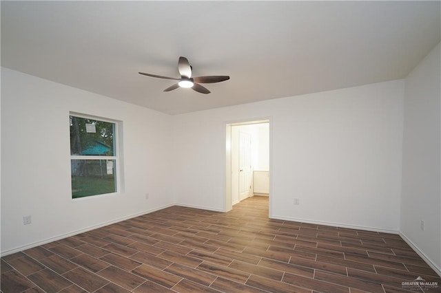 spare room featuring ceiling fan and dark wood-type flooring