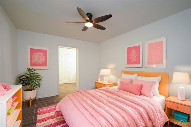 bedroom with ceiling fan and dark hardwood / wood-style flooring