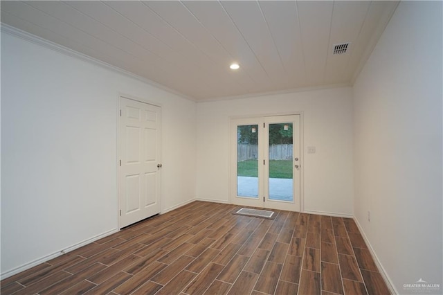 spare room featuring dark hardwood / wood-style flooring and ornamental molding