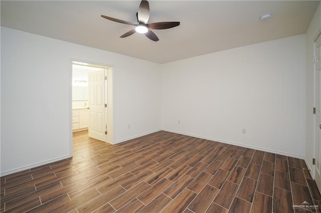 spare room featuring ceiling fan and dark hardwood / wood-style flooring