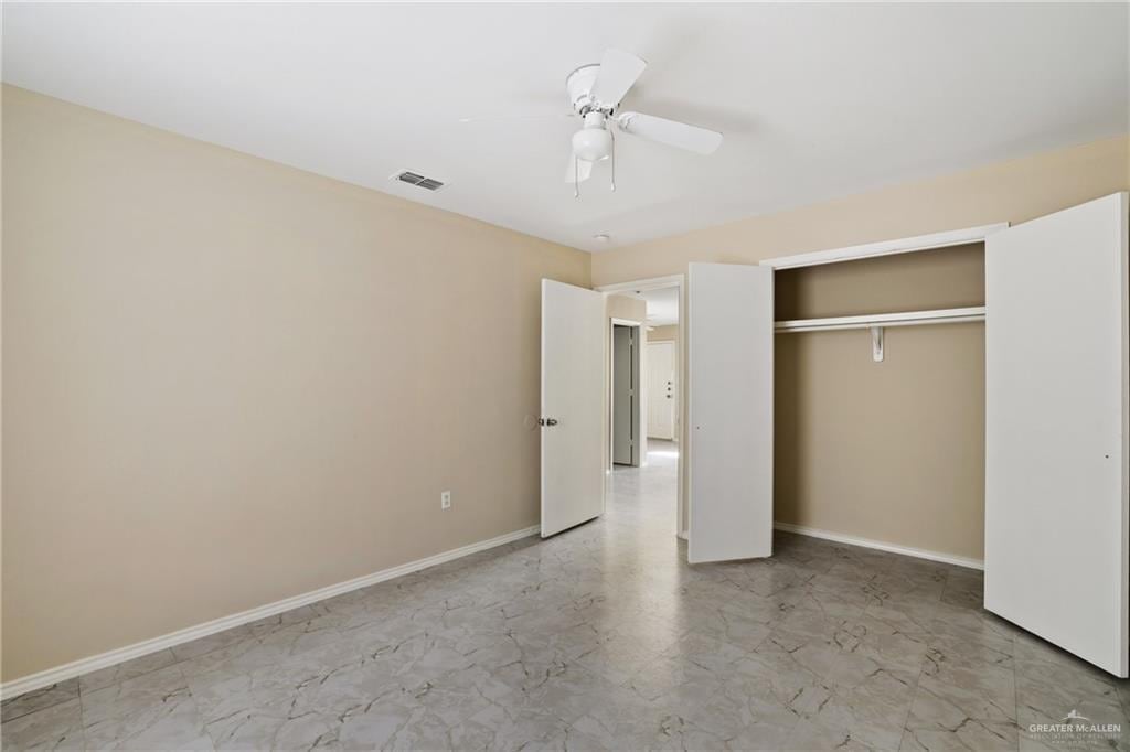 303 Gastel Cir, Edinburg, TX 78539 - unfurnished bedroom featuring a closet, visible vents, a ceiling fan, and baseboards