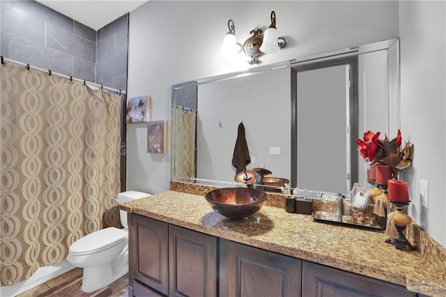 bathroom with toilet, vanity, and a shower with curtain