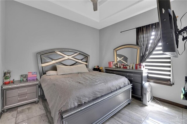 bedroom featuring ceiling fan and baseboards
