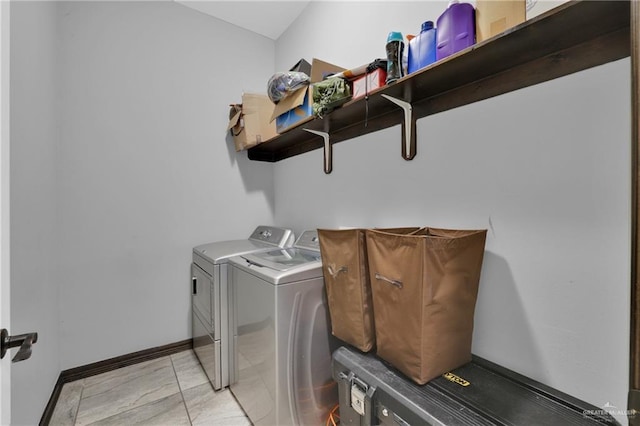 laundry area with separate washer and dryer, laundry area, and baseboards