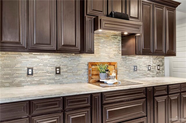 13500 35th St, Edinburg, TX 78541 - kitchen with dark brown cabinets, decorative backsplash, and light stone counters