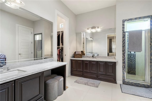 13500 35th St, Edinburg, TX 78541 - full bathroom featuring two vanities, tile patterned floors, a stall shower, and a walk in closet