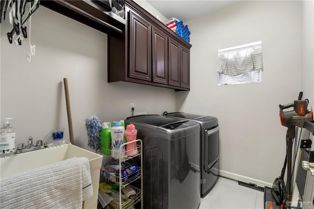 13500 35th St, Edinburg, TX 78541 - laundry room featuring washing machine and dryer, cabinet space, and light tile patterned floors