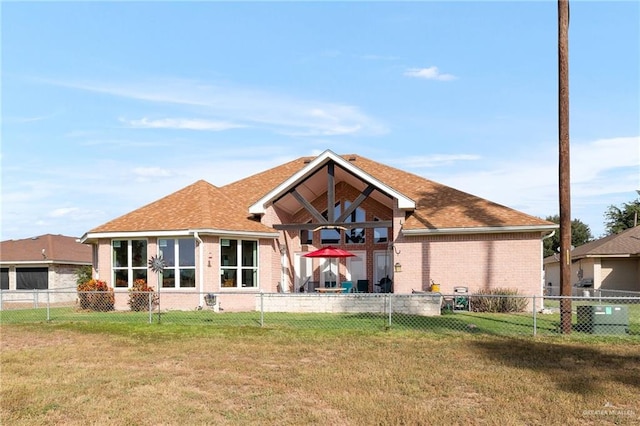 back of house featuring a lawn and cooling unit