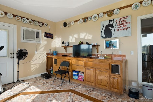 interior space with butcher block countertops and a wall mounted AC