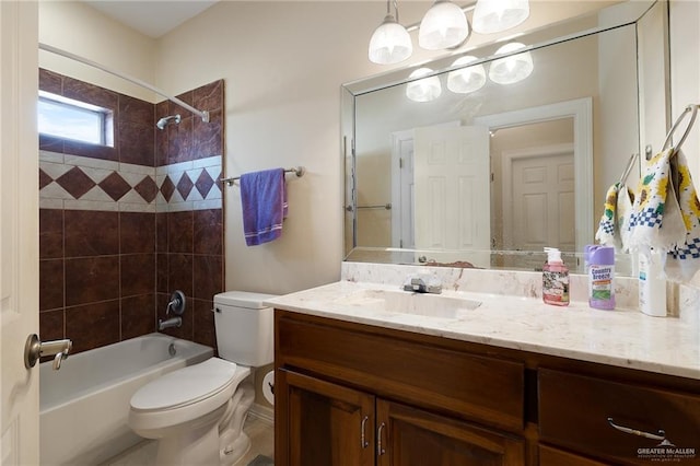 full bathroom with toilet, vanity, and tiled shower / bath