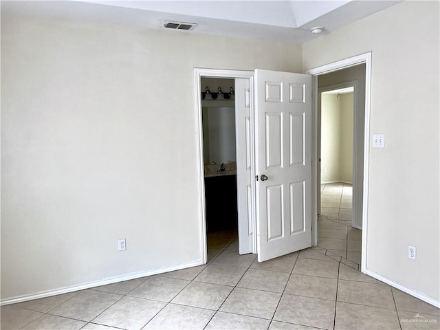 unfurnished bedroom with light tile patterned floors