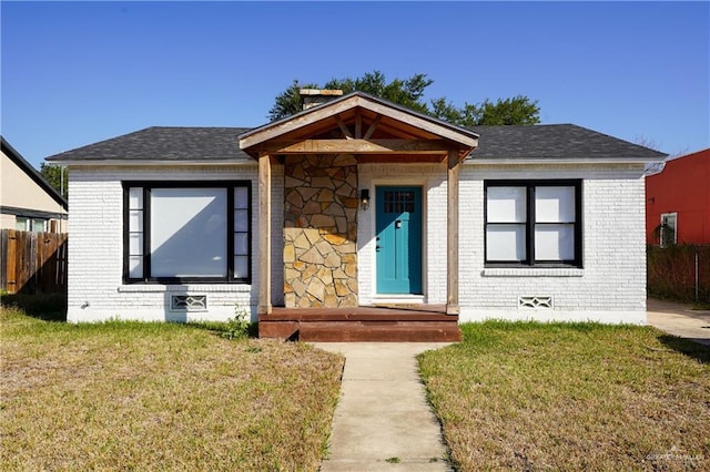 bungalow-style home featuring a front yard