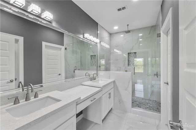 bathroom with marble finish floor, a marble finish shower, visible vents, and a sink