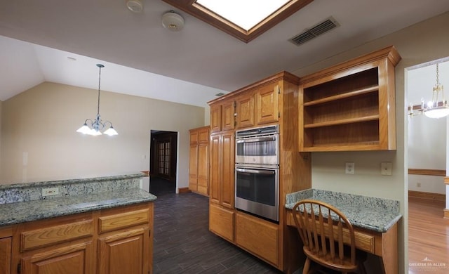 kitchen featuring vaulted ceiling, dark hardwood / wood-style floors, stainless steel double oven, and a notable chandelier