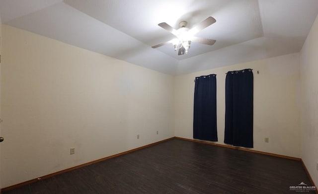 empty room with dark wood-type flooring, ceiling fan, and vaulted ceiling