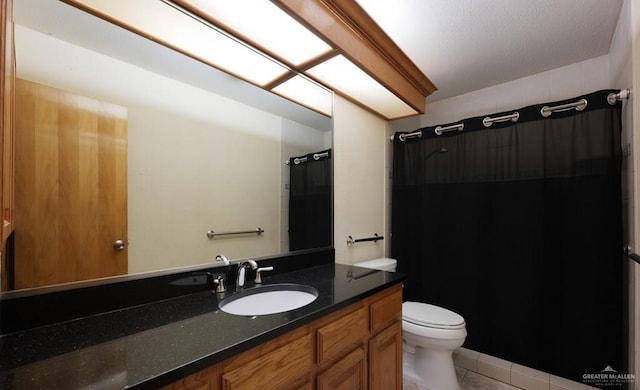 bathroom with tile patterned floors, toilet, and vanity