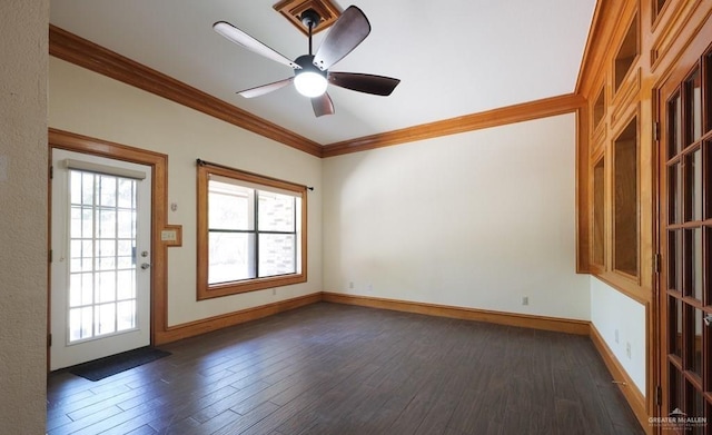 spare room featuring dark hardwood / wood-style flooring, ornamental molding, and ceiling fan