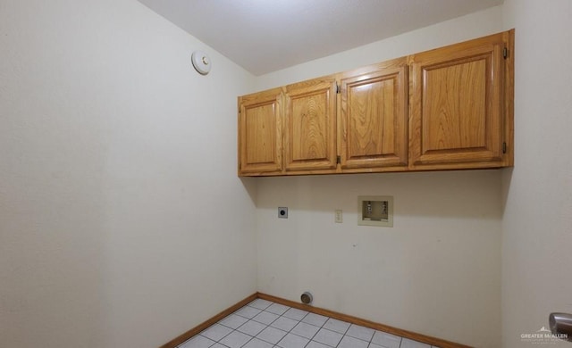 laundry area featuring cabinets, hookup for a washing machine, hookup for an electric dryer, and light tile patterned floors