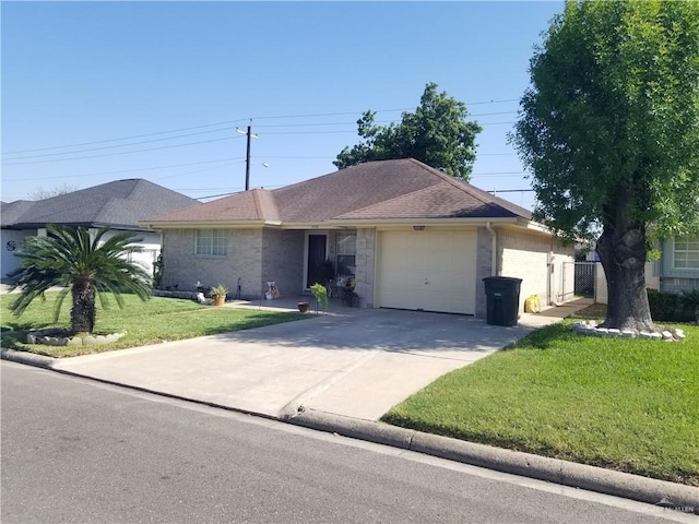 ranch-style house featuring an attached garage, a shingled roof, driveway, and a front yard