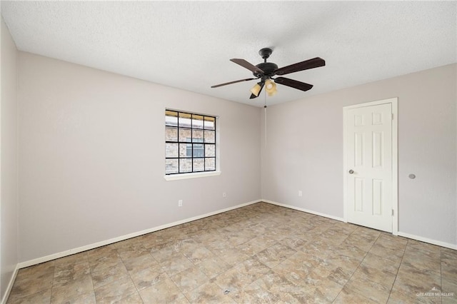 spare room with a textured ceiling and ceiling fan