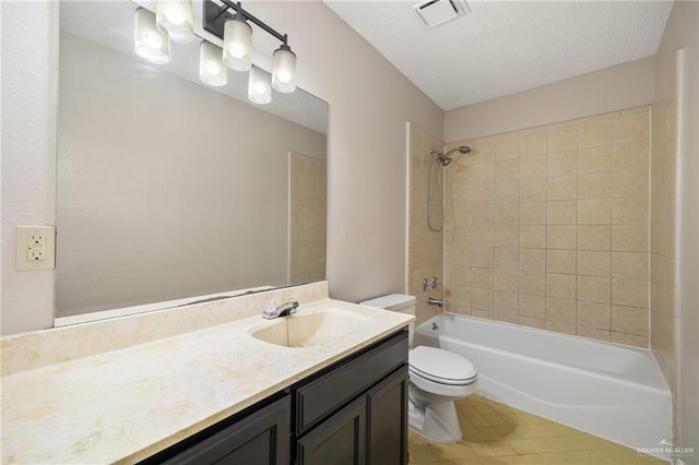 full bathroom with tiled shower / bath combo, toilet, a textured ceiling, and vanity