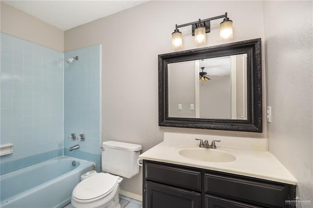 full bathroom with vanity, tiled shower / bath, tile patterned flooring, ceiling fan, and toilet