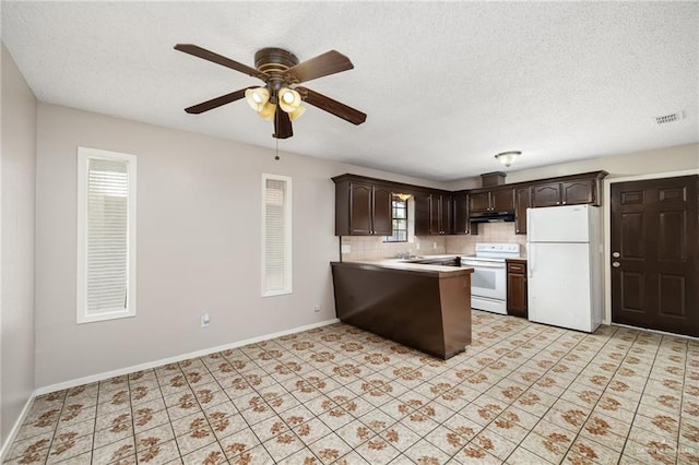 kitchen with a textured ceiling, white appliances, and dark brown cabinetry